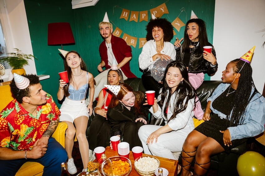 Party favors for adults: group of people wearing party hats and drinking